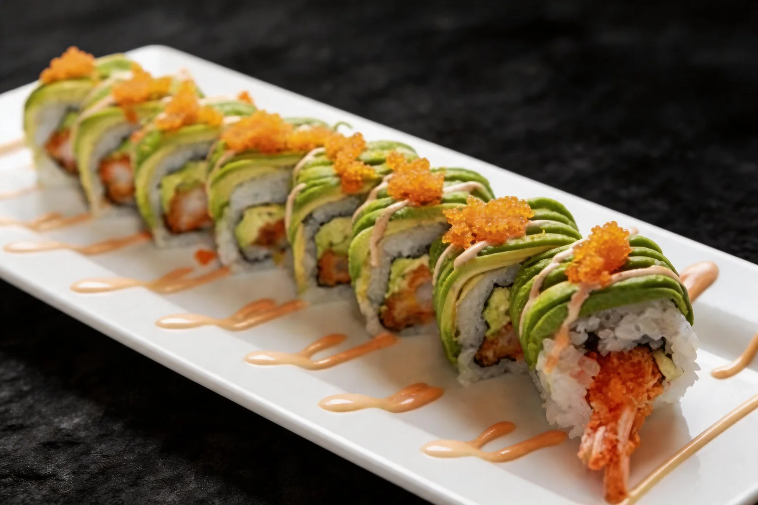 Maki Dragon on a white plate, dark background.